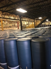 a large warehouse filled with blue barrels